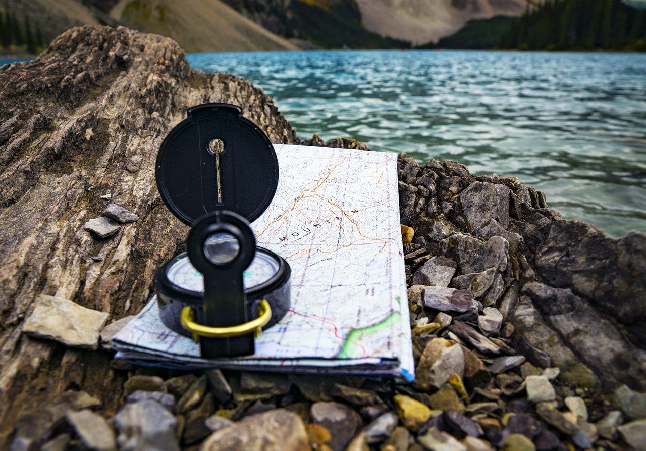 Compass on map beside a river